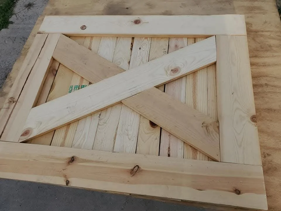 Unfinished pine barn door with diagonal bracing and frame-and-panel construction