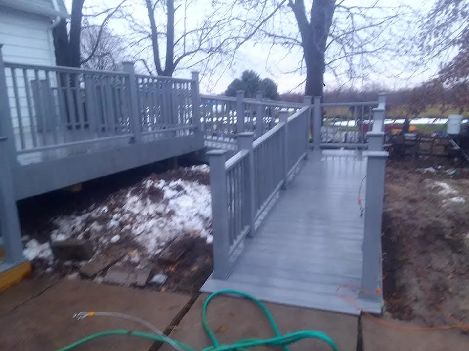 White vinyl deck railing and composite decking platform with walkway access