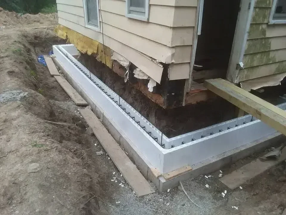 New white aluminum fascia and soffit installation with gutter system on residential roofline