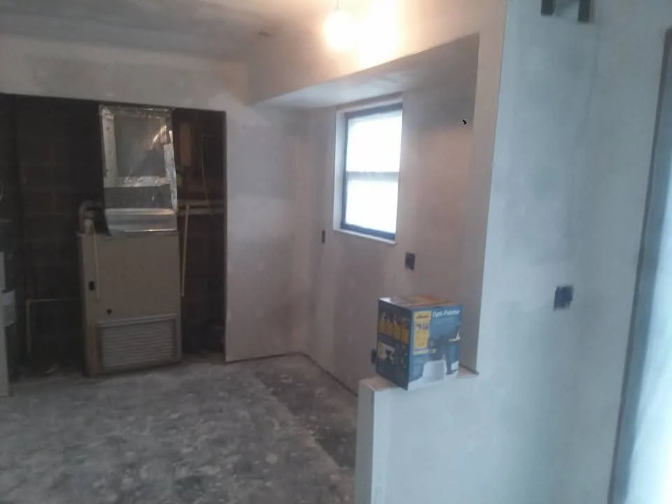 Interior room with white drywall, taped joints, window opening, and electrical boxes installed