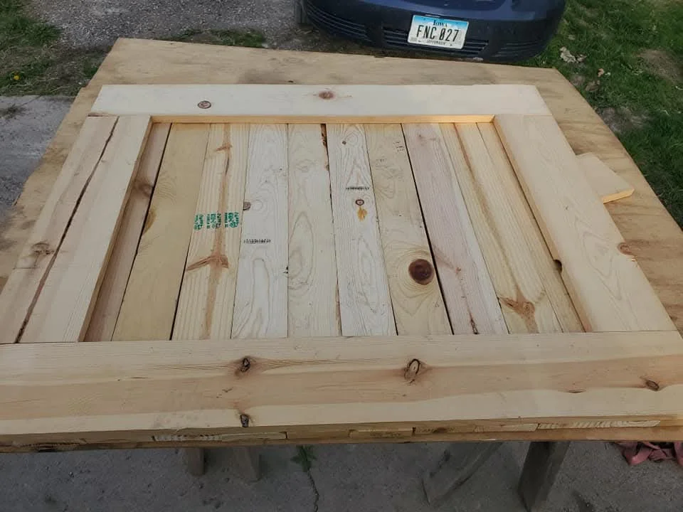 Wooden cabinet with dimensional lumber framing and tongue-and-groove planking