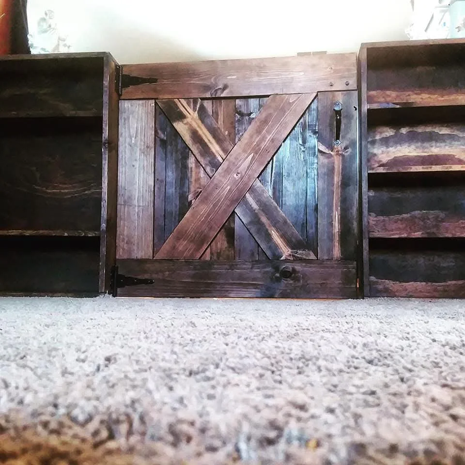 Rustic wooden cabinet door with X-brace design, aged wood planks, and metal hardware