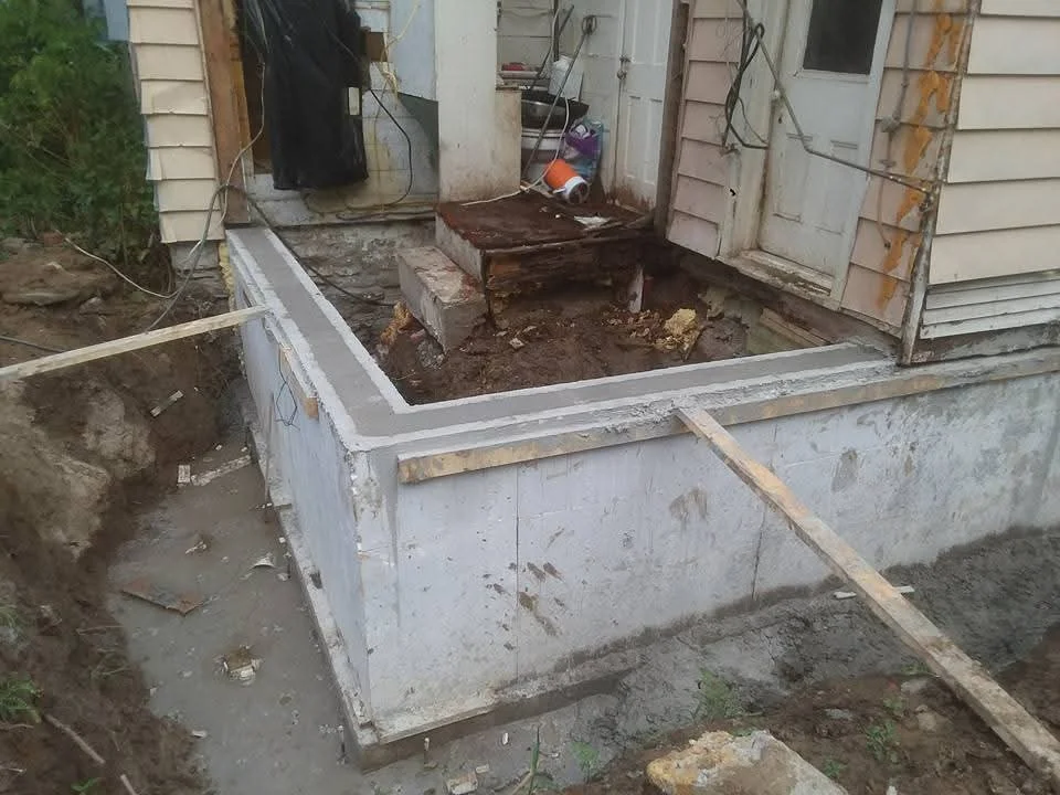 Concrete foundation walls with steel bracing in residential excavation site