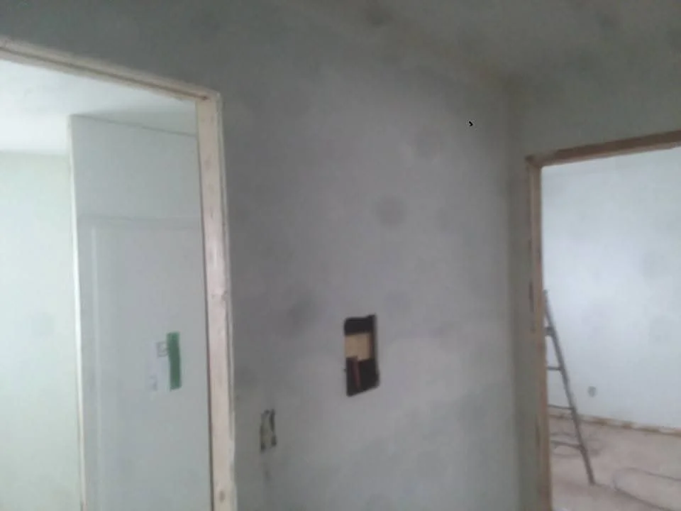 Interior drywall installation with framed walls, electrical boxes, and door openings