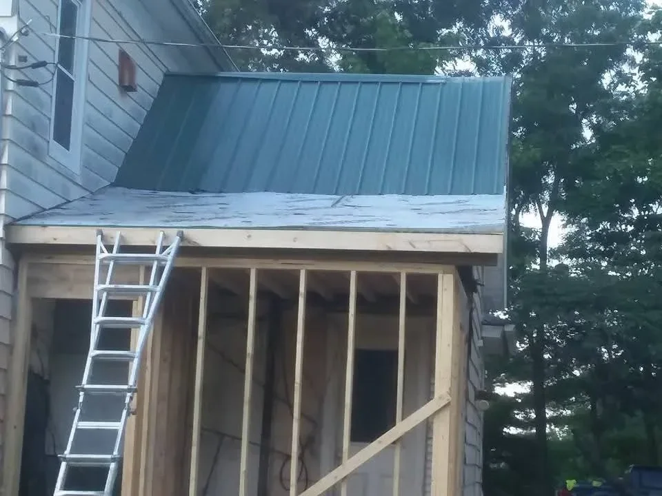 Standing seam metal roof and corrugated metal siding with metal deck railing